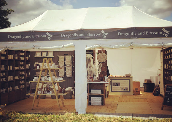 The fully stocked stand with Dragonfly and Blossom products at the Cotswold Show on a hot sunny day